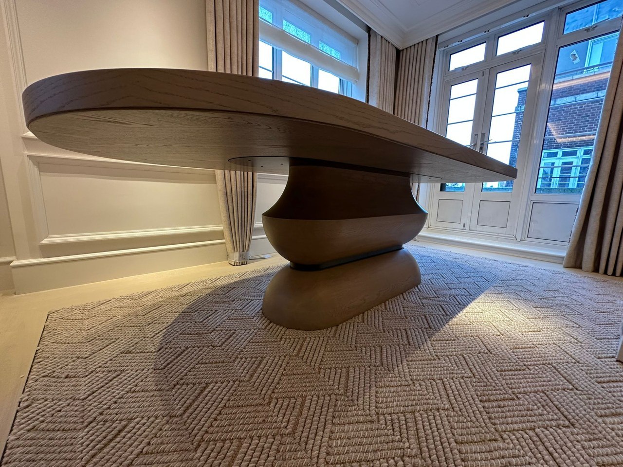 Completed solid oak table photographed in its interior setting