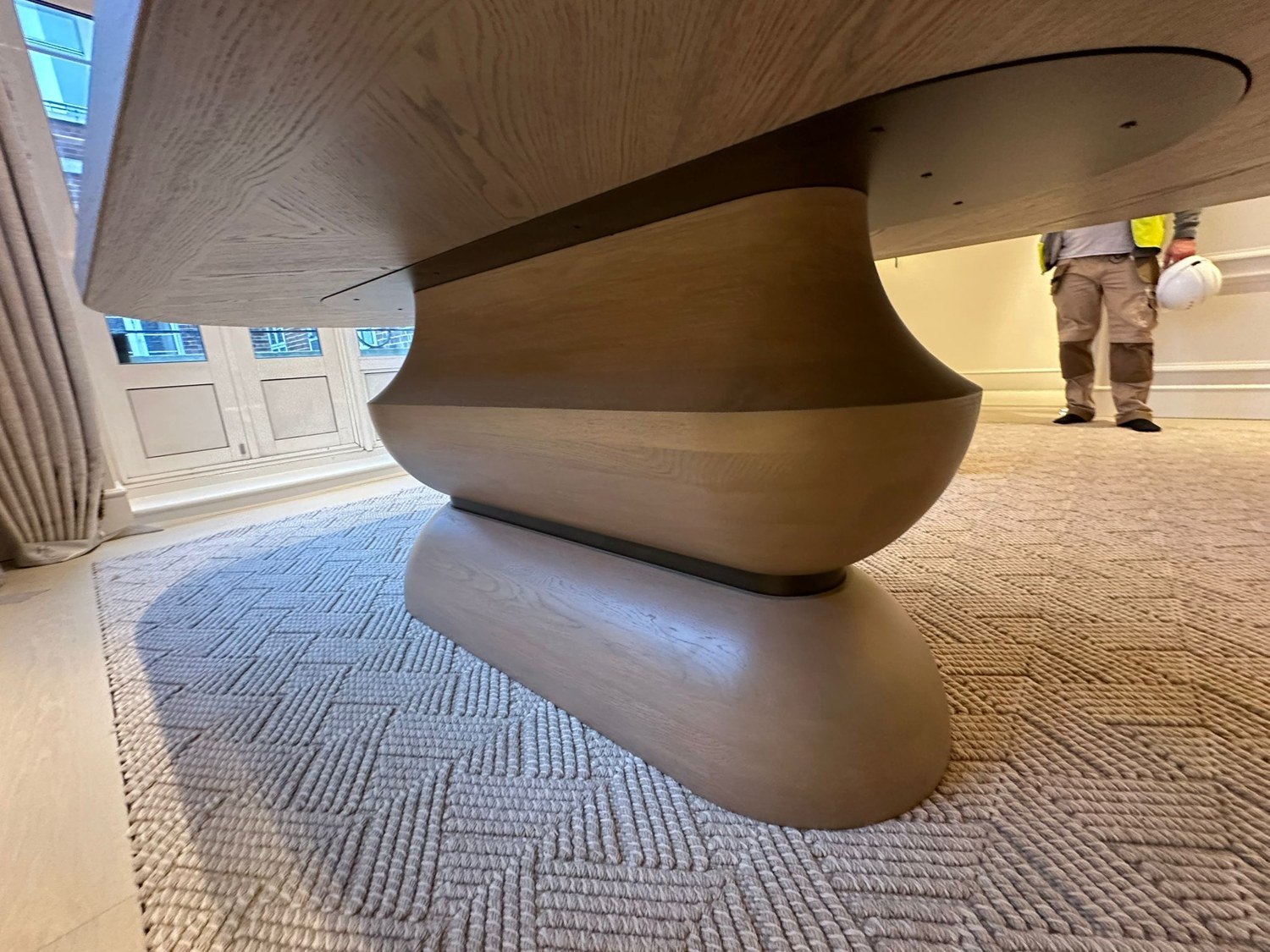 Sculpted oak base · Curved form